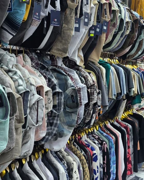 Men's shirts, polo T-shirts and jeans on hangers at Safa Marwa, Bur Dubai